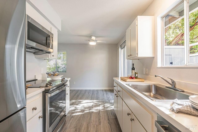 106 Oliva Ct Unit A, Novato, CA 94947 - kitchen with stainless steel appliances, a sink, light countertops, and wood finished floors