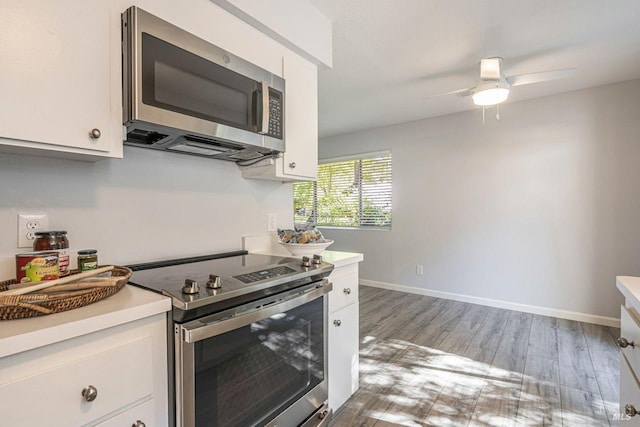106 Oliva Ct Unit A, Novato, CA 94947 - kitchen with appliances with stainless steel finishes, white cabinets, light countertops, and light wood-style floors