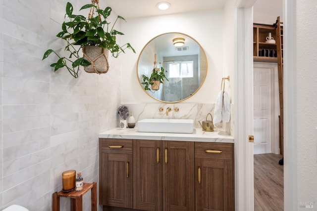 4588 Bennett Valley Rd, Santa Rosa, CA 95404 - bathroom featuring vanity, tile walls, wood finished floors, and backsplash