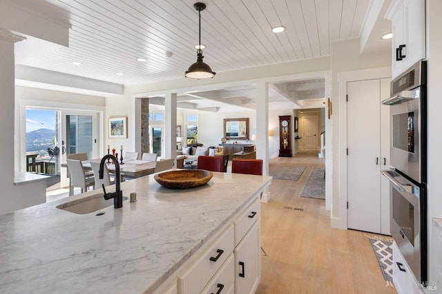 2557 Trinity Rd, Glen Ellen, CA 95442 - kitchen with open floor plan, light wood-style flooring, wooden ceiling, pendant lighting, and double oven