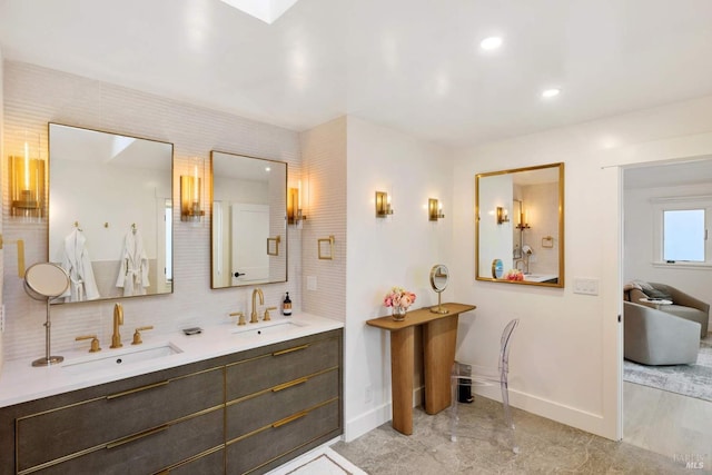 2557 Trinity Rd, Glen Ellen, CA 95442 - bathroom featuring baseboards, double vanity, marble finish flooring, decorative backsplash, and recessed lighting