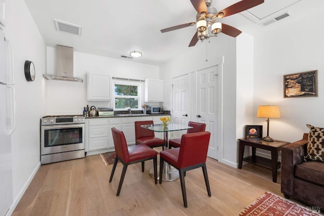 2557 Trinity Rd, Glen Ellen, CA 95442 - kitchen with stainless steel appliances, wall chimney exhaust hood, a sink, and light wood-style flooring
