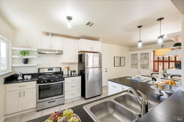 238 Ebbetts Pass Rd, Vallejo, CA 94589 - kitchen featuring stainless steel appliances, dark countertops, a sink, under cabinet range hood, and light tile patterned floors