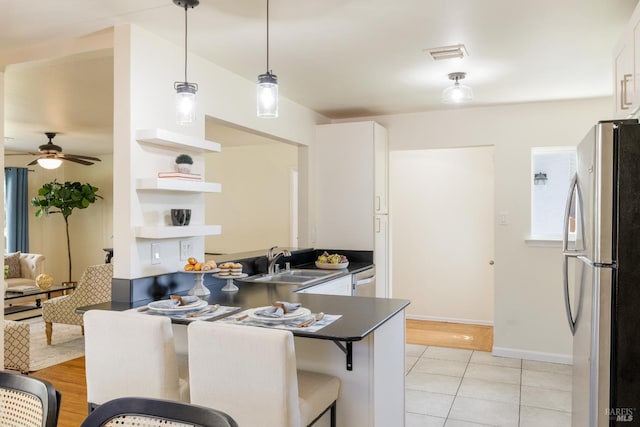 238 Ebbetts Pass Rd, Vallejo, CA 94589 - kitchen featuring freestanding refrigerator, a sink, dark countertops, and white cabinetry