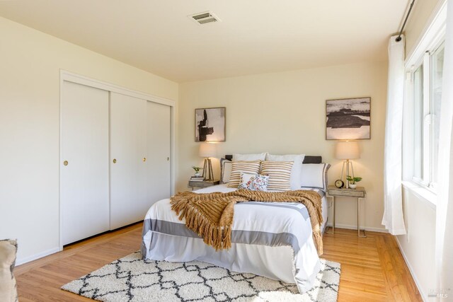 238 Ebbetts Pass Rd, Vallejo, CA 94589 - bedroom with wood finished floors, a closet, baseboards, and multiple windows