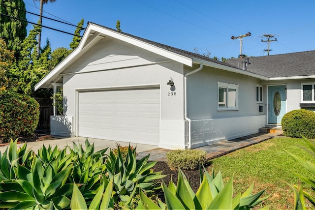 238 Ebbetts Pass Rd, Vallejo, CA 94589 - view of home's exterior with stucco siding, concrete driveway, roof with shingles, and brick siding