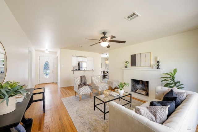 238 Ebbetts Pass Rd, Vallejo, CA 94589 - living area with light wood-type flooring, a ceiling fan, and a fireplace