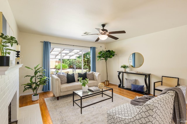 238 Ebbetts Pass Rd, Vallejo, CA 94589 - living area featuring baseboards, a ceiling fan, wood finished floors, and a brick fireplace