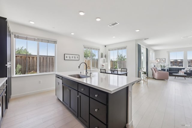 2413 Village Square Blvd, Fairfield, CA 94533 - kitchen featuring a sink, light countertops, stainless steel dishwasher, open floor plan, and an island with sink