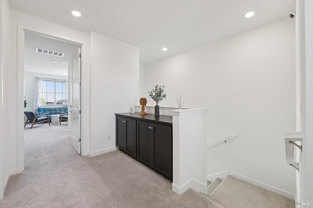 2413 Village Square Blvd, Fairfield, CA 94533 - hallway featuring light carpet, an upstairs landing, baseboards, and recessed lighting