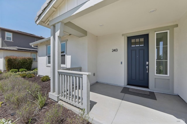 2413 Village Square Blvd, Fairfield, CA 94533 - doorway to property with stucco siding and covered porch
