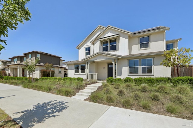 2413 Village Square Blvd, Fairfield, CA 94533 - traditional home featuring solar panels, stucco siding, and covered porch
