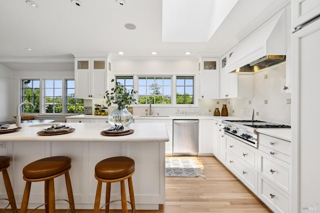 37 Rancheria Rd, Kentfield, CA 94904 - kitchen with stainless steel dishwasher, gas stovetop, a sink, premium range hood, and healthy amount of natural light