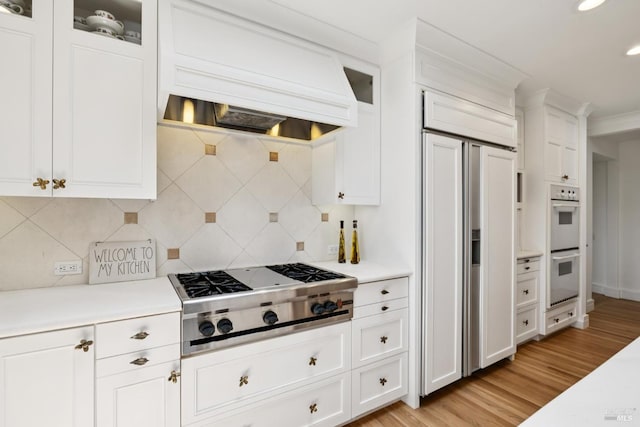 37 Rancheria Rd, Kentfield, CA 94904 - kitchen with stainless steel gas stovetop, custom range hood, paneled built in refrigerator, double oven, and light wood-style floors
