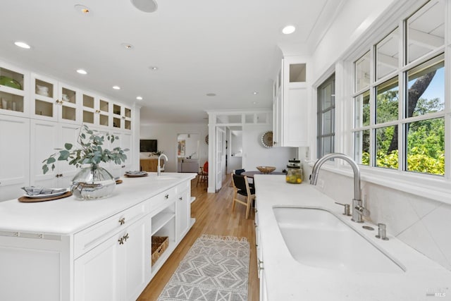 37 Rancheria Rd, Kentfield, CA 94904 - kitchen featuring a sink, white cabinetry, light countertops, glass insert cabinets, and light wood-style floors