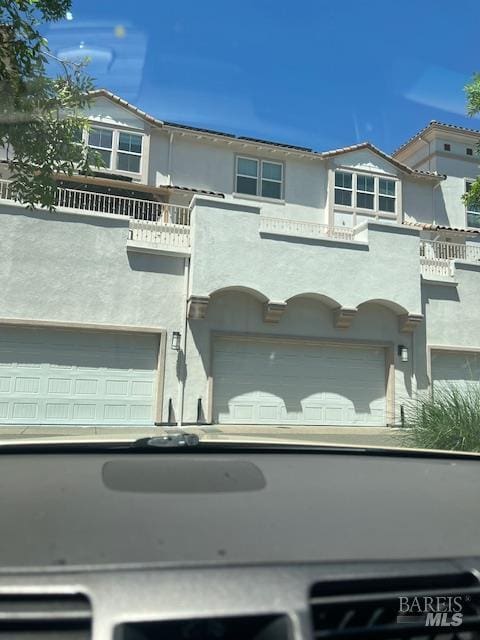 126 Johnson St, Windsor, CA 95492 - view of front of home featuring a balcony, a garage, and stucco siding