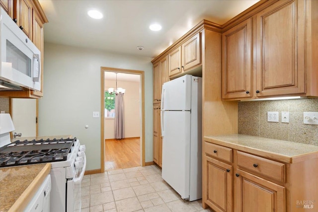 kitchen featuring white appliances, decorative backsplash, a chandelier, tile countertops, and recessed lighting