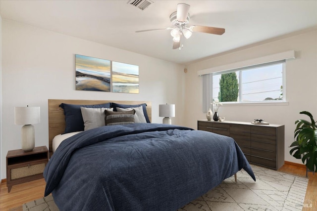 bedroom with light wood-type flooring and ceiling fan