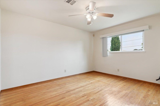 spare room featuring light wood-type flooring and ceiling fan