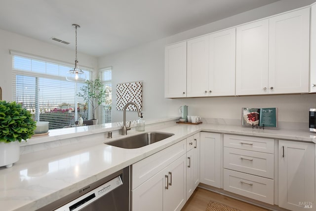 306 Commodore Dr, Richmond, CA 94804 - kitchen featuring white cabinets, pendant lighting, light wood-style floors, and light stone countertops