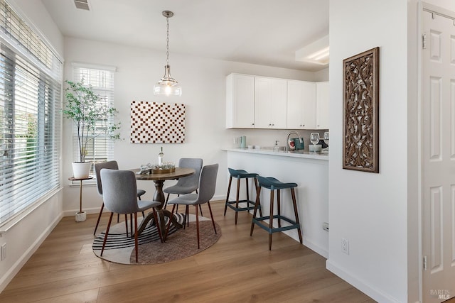 306 Commodore Dr, Richmond, CA 94804 - dining area with light wood-type flooring and baseboards