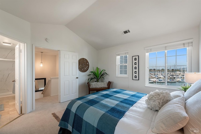 306 Commodore Dr, Richmond, CA 94804 - bedroom with lofted ceiling, light carpet, a water view, and connected bathroom