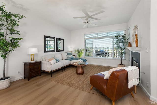 306 Commodore Dr, Richmond, CA 94804 - living area featuring light wood-style flooring, a ceiling fan, and a glass covered fireplace