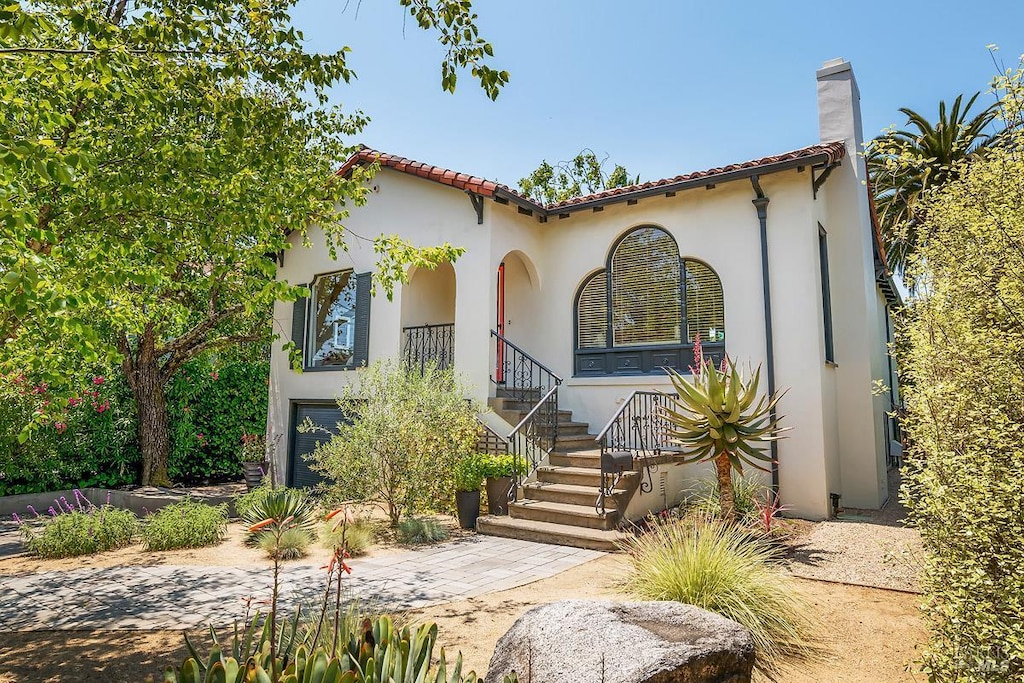 309 G St, San Rafael, CA 94901 - mediterranean / spanish house featuring stucco siding, a chimney, and a tile roof