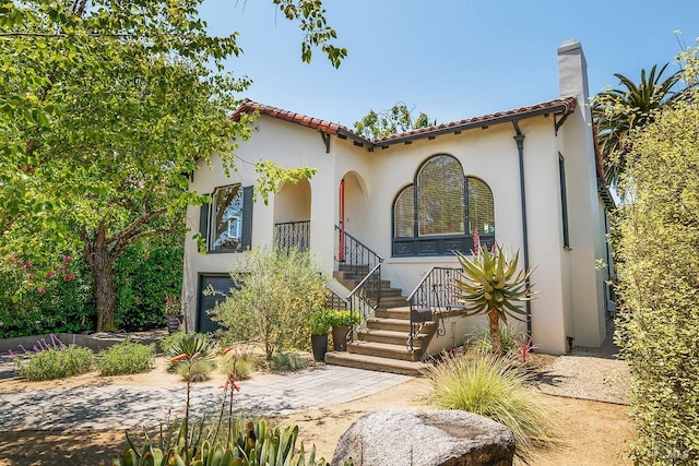 309 G St, San Rafael, CA 94901 - mediterranean / spanish house featuring stucco siding, a chimney, and a tile roof