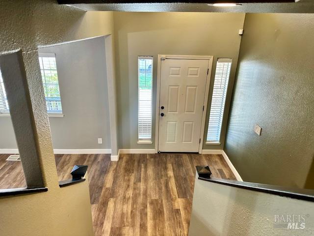 1540 Mccarthy Ct, Dixon, CA 95620 - entryway featuring wood finished floors, healthy amount of natural light, and a textured wall