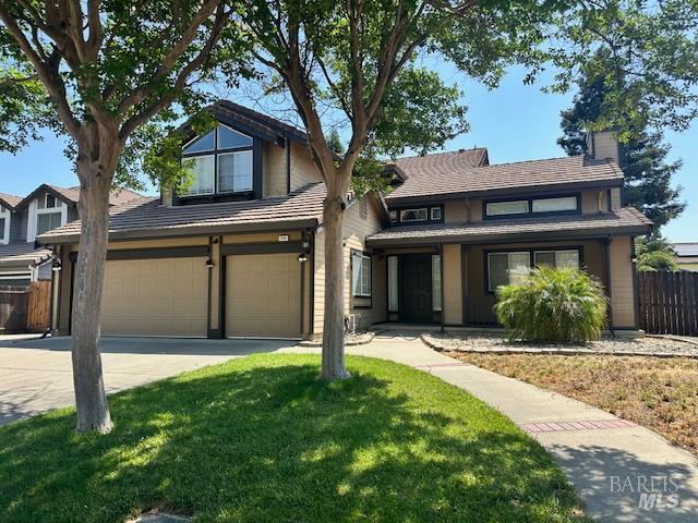 1540 Mccarthy Ct, Dixon, CA 95620 - traditional-style home with an attached garage, driveway, and a chimney