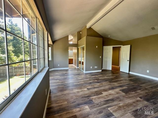 1540 Mccarthy Ct, Dixon, CA 95620 - spare room with beamed ceiling, dark wood-style floors, and high vaulted ceiling