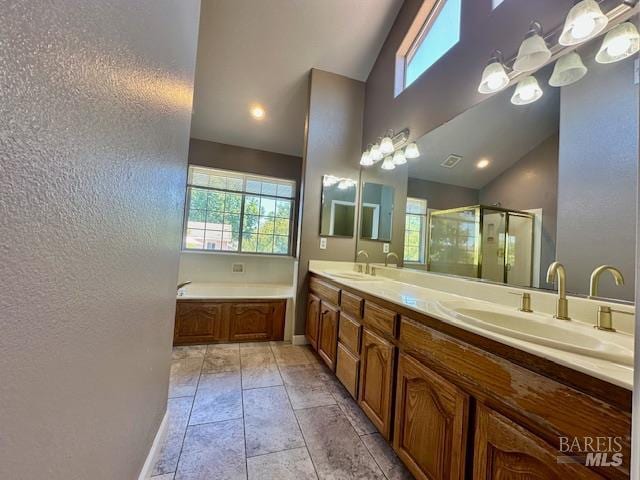 1540 Mccarthy Ct, Dixon, CA 95620 - full bathroom with a textured wall, a stall shower, healthy amount of natural light, double vanity, and a garden tub
