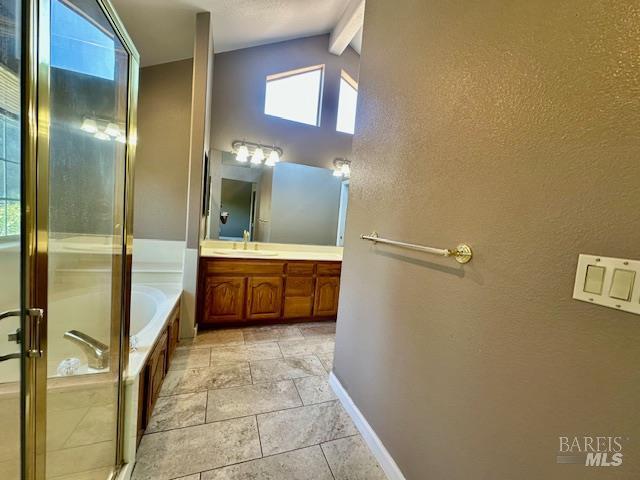 1540 Mccarthy Ct, Dixon, CA 95620 - bathroom featuring vanity, a stall shower, a bath, and a textured wall
