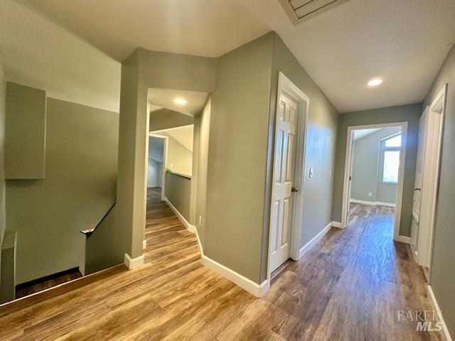 1540 Mccarthy Ct, Dixon, CA 95620 - hallway with wood finished floors and an upstairs landing