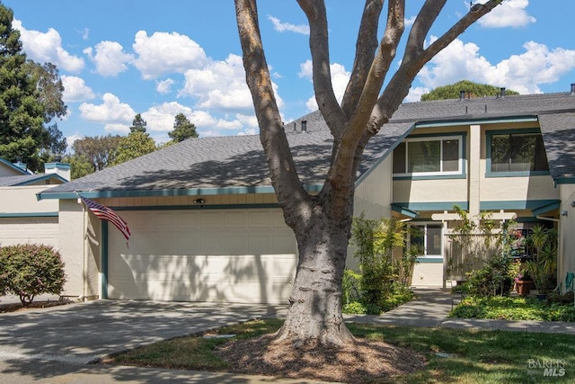 1800 London Dr, Benicia, CA 94510 - view of front of property with driveway, a garage, a shingled roof, and stucco siding