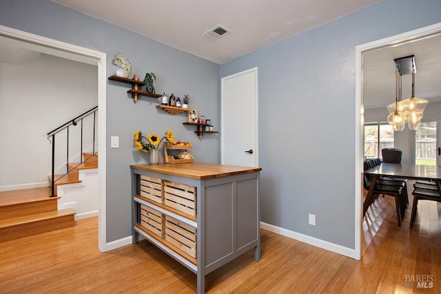 1800 London Dr, Benicia, CA 94510 - corridor featuring light wood-type flooring, stairs, and baseboards