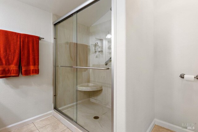 1800 London Dr, Benicia, CA 94510 - bathroom featuring a shower stall, tile patterned floors, and baseboards