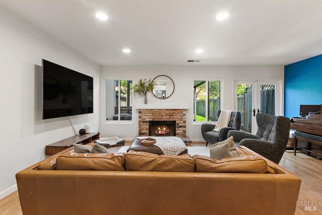 1800 London Dr, Benicia, CA 94510 - living area featuring healthy amount of natural light, light wood finished floors, recessed lighting, and a brick fireplace