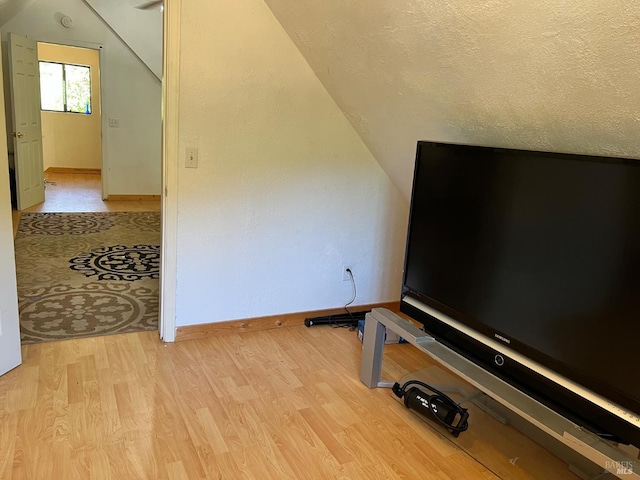 9826 Meadow Dr, Cobb, CA 95426 - bonus room featuring lofted ceiling, light wood-type flooring, and a textured ceiling
