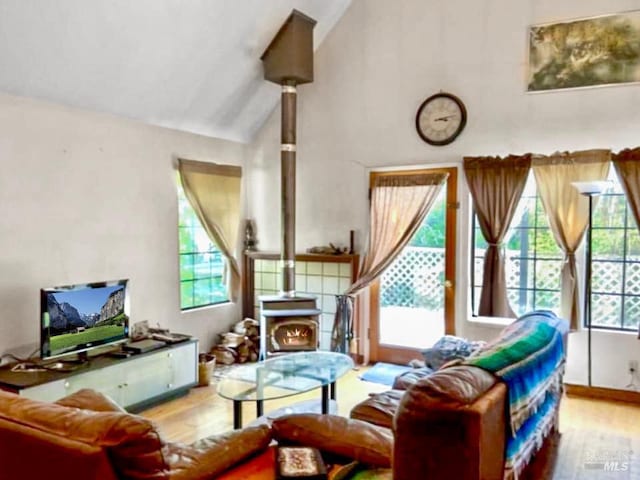 9826 Meadow Dr, Cobb, CA 95426 - living area featuring wood finished floors, vaulted ceiling, and a wood stove