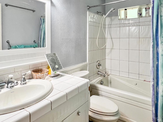 9826 Meadow Dr, Cobb, CA 95426 - bathroom with a textured wall, shower / tub combo with curtain, vanity, a wainscoted wall, and decorative backsplash