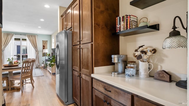 2676 Franz Kafka Ave, Santa Rosa, CA 95404 - kitchen with freestanding refrigerator, light wood finished floors, light countertops, recessed lighting, and brown cabinets
