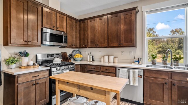 2676 Franz Kafka Ave, Santa Rosa, CA 95404 - kitchen with stainless steel appliances, a sink, light countertops, and dark brown cabinetry