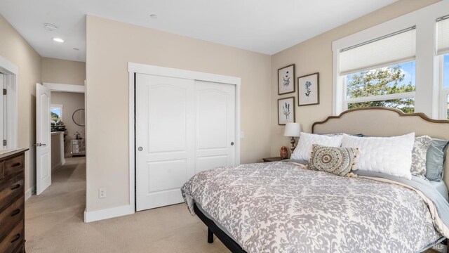 2676 Franz Kafka Ave, Santa Rosa, CA 95404 - bedroom featuring light carpet, a closet, multiple windows, baseboards, and recessed lighting