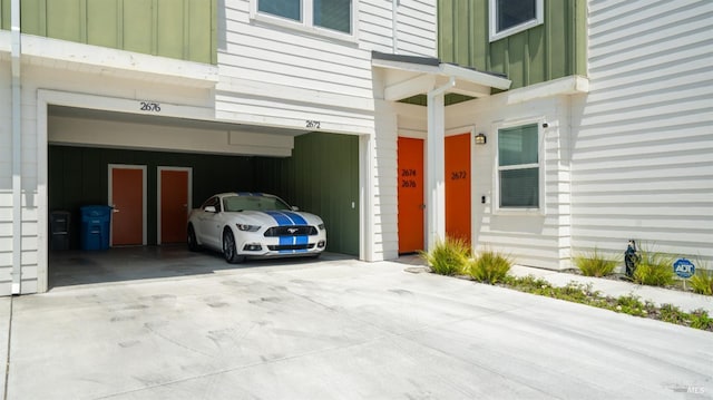 2676 Franz Kafka Ave, Santa Rosa, CA 95404 - property entrance with board and batten siding, an attached garage, and driveway