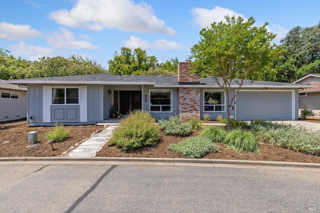 6518 Meadowgreen Pl, Santa Rosa, CA 95409 - ranch-style home with a chimney, an attached garage, driveway, and board and batten siding