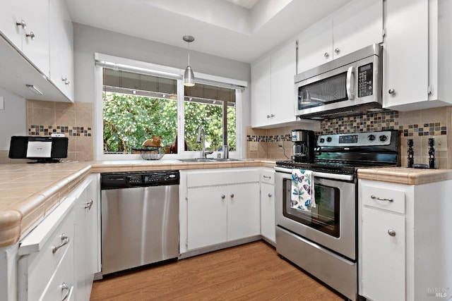 6518 Meadowgreen Pl, Santa Rosa, CA 95409 - kitchen with appliances with stainless steel finishes, tile countertops, and white cabinetry