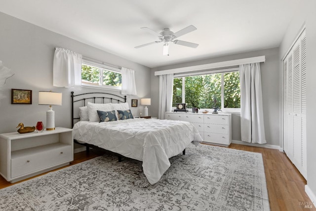 6518 Meadowgreen Pl, Santa Rosa, CA 95409 - bedroom with multiple windows, light wood-type flooring, a ceiling fan, and baseboards