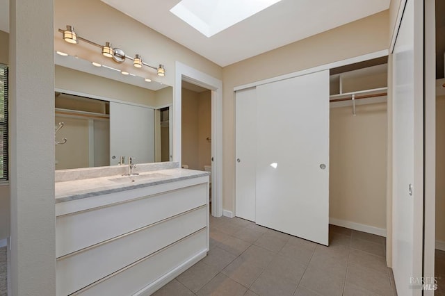 827 Wild Oak Dr, Santa Rosa, CA 95409 - full bathroom with vanity, a skylight, tile patterned floors, a walk in closet, and baseboards